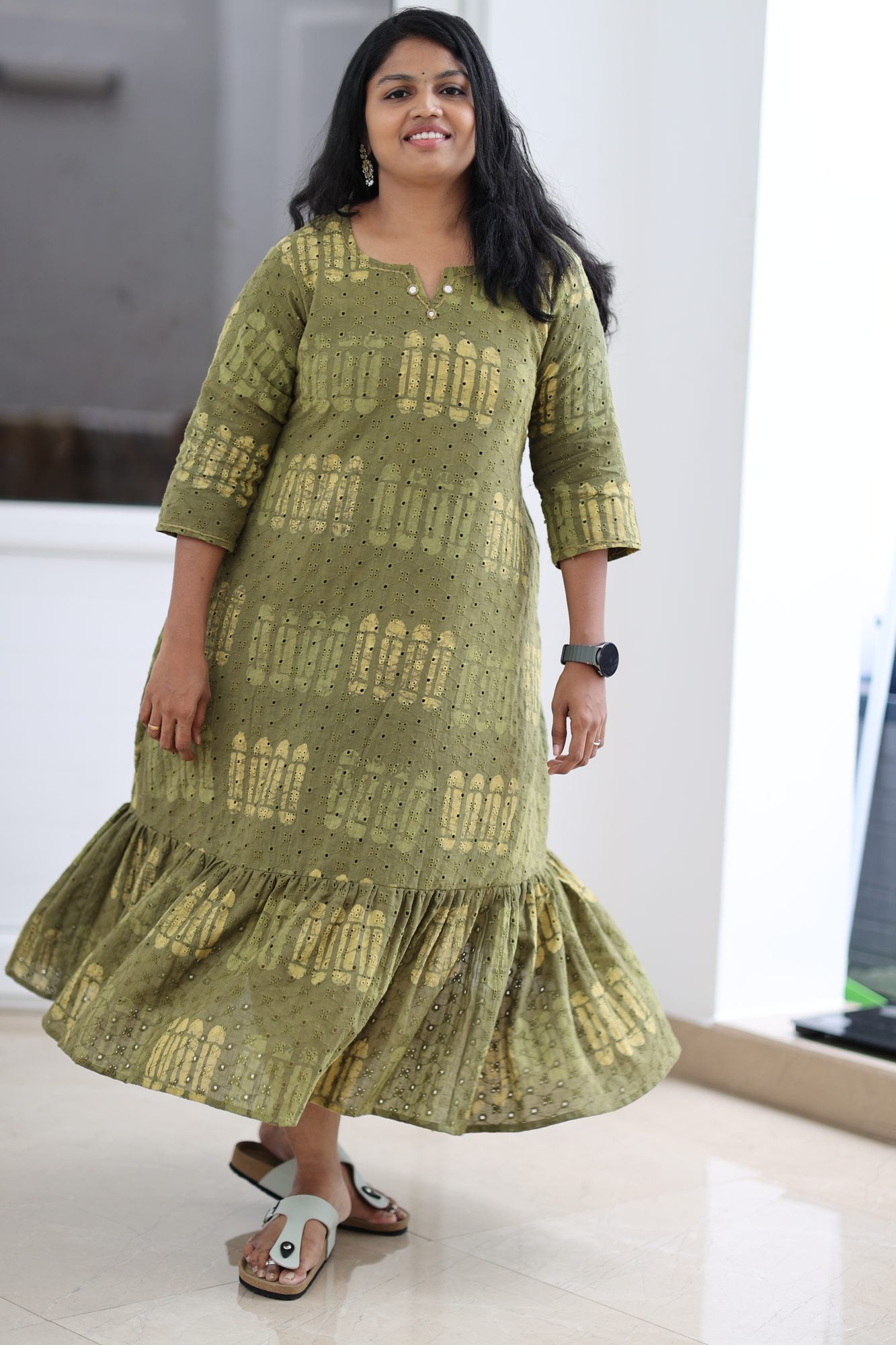 The dress in movement, showing flow and tiered hem