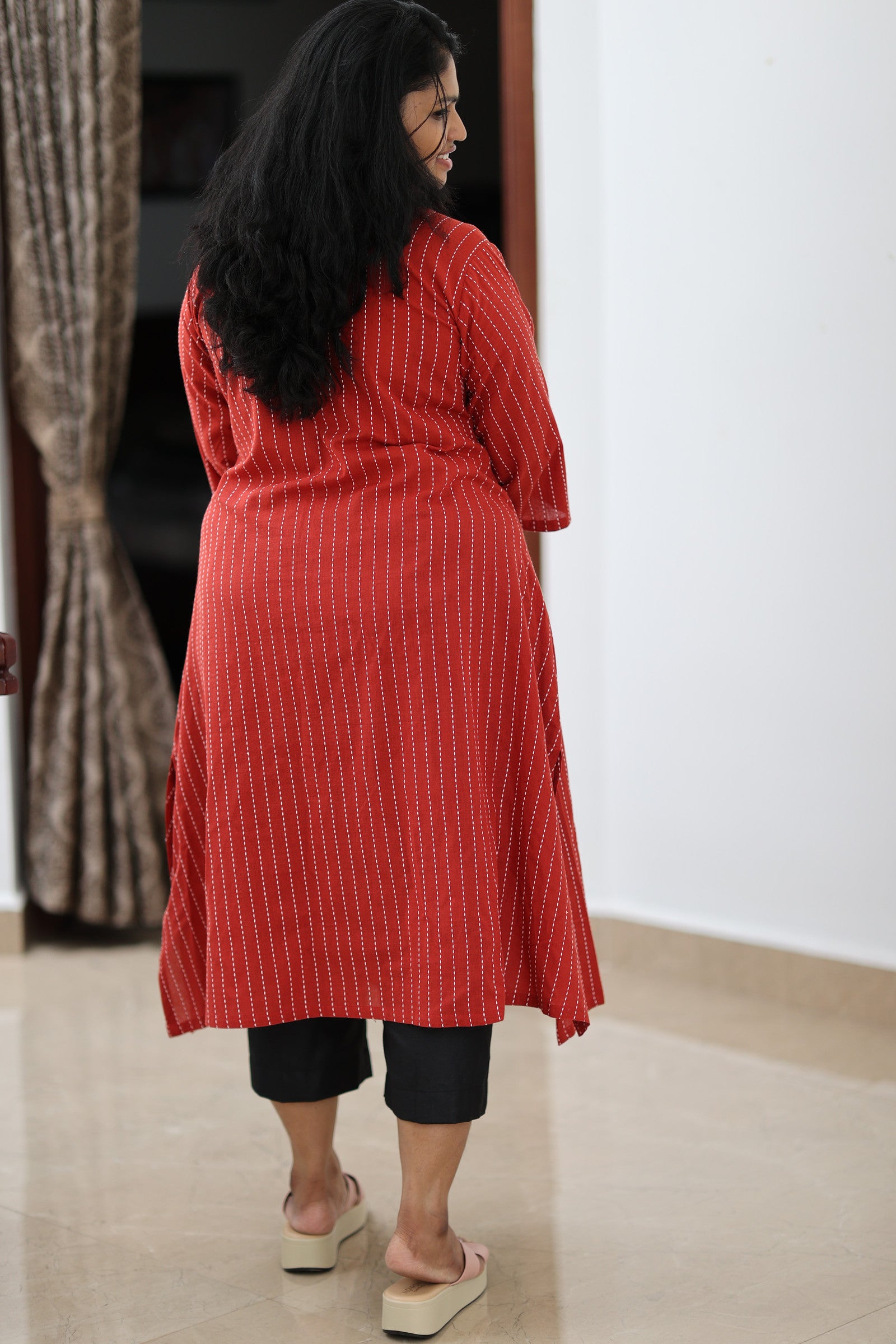 Back view of red striped office kurta showing coverage and relaxed fit