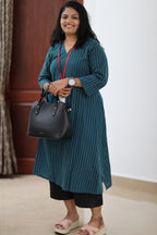 30+ woman wearing teal striped office kurta with black trousers and work bag