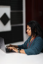 30+ woman working on laptop in teal striped office kurta