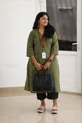 30+ woman wearing olive striped office kurta with black trousers and work bag