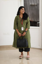 30+ woman wearing olive striped office kurta with black trousers and work bag
