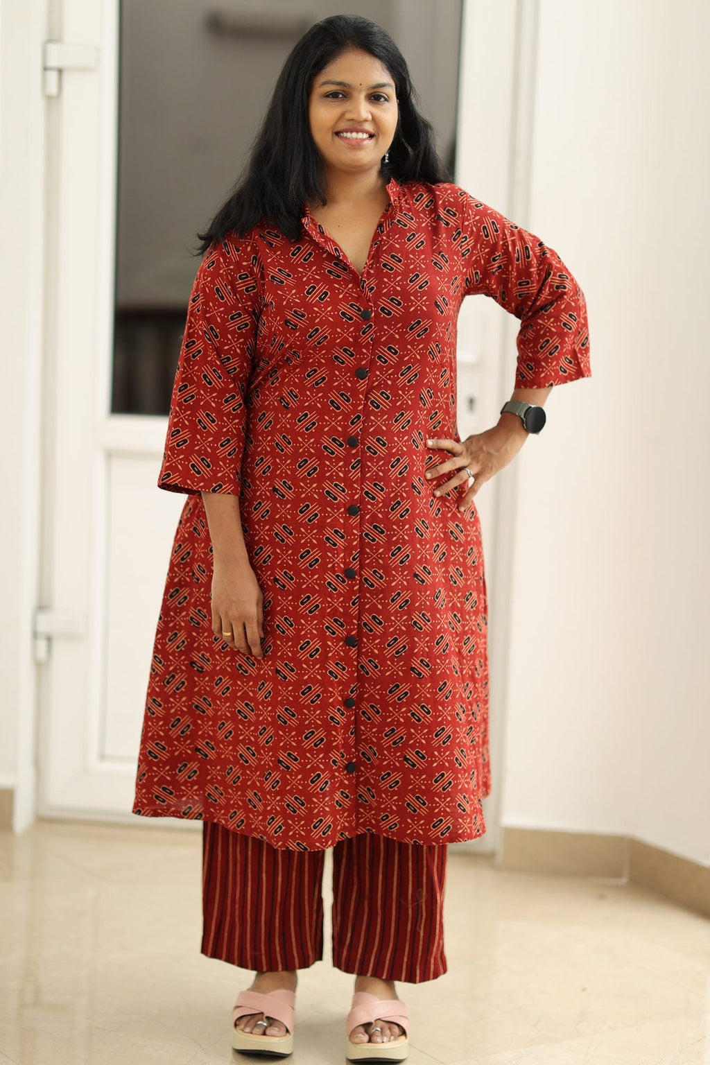 Madder red Ajrakh kurta set, hand on hip