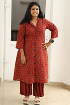 Madder red Ajrakh kurta set, hand on hip