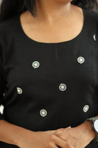 Round neck and white embroidered floral motifs
