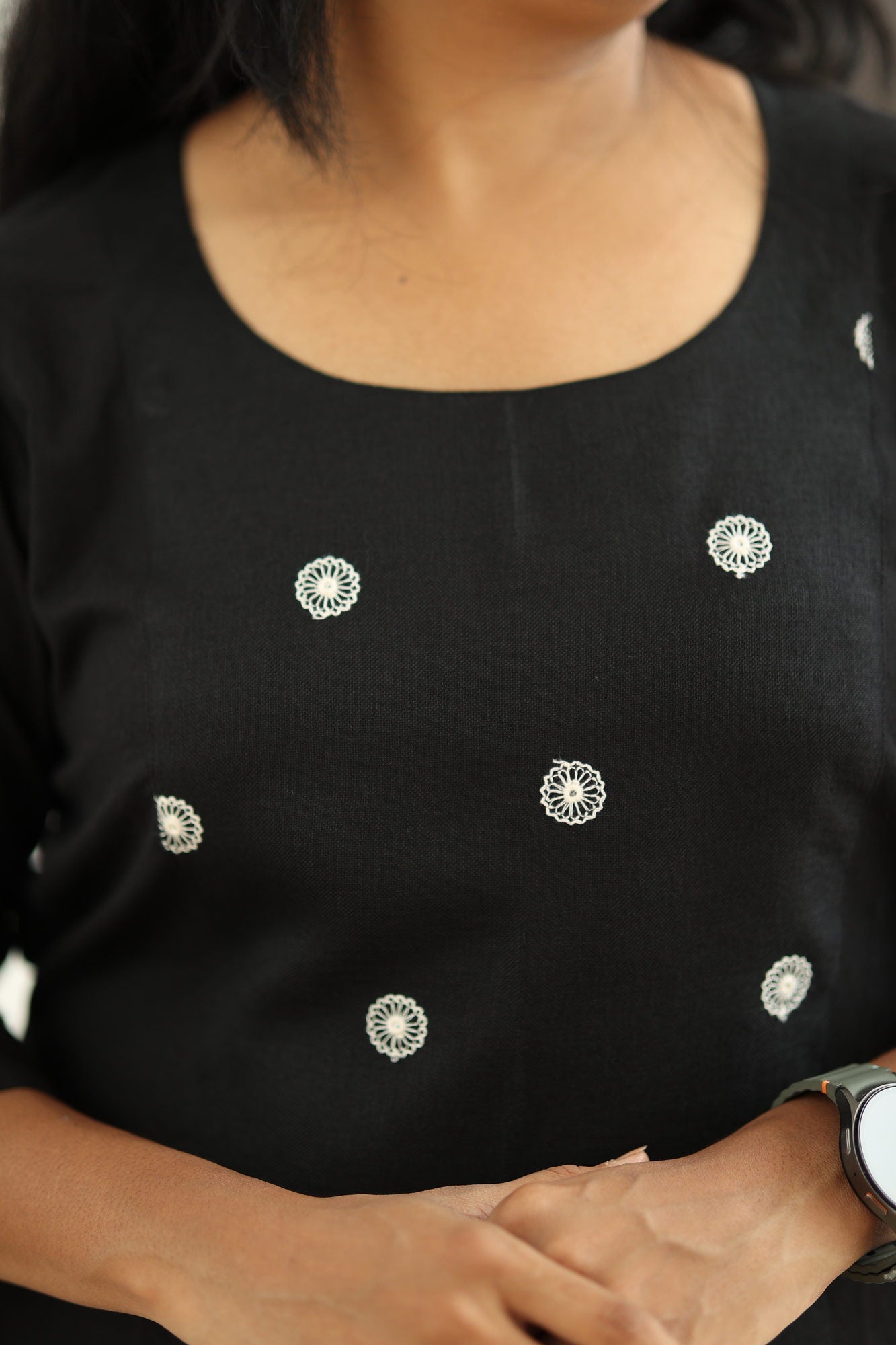 Round neck and white embroidered floral motifs