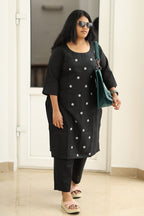 Black embroidered kurta set, styled with a bag