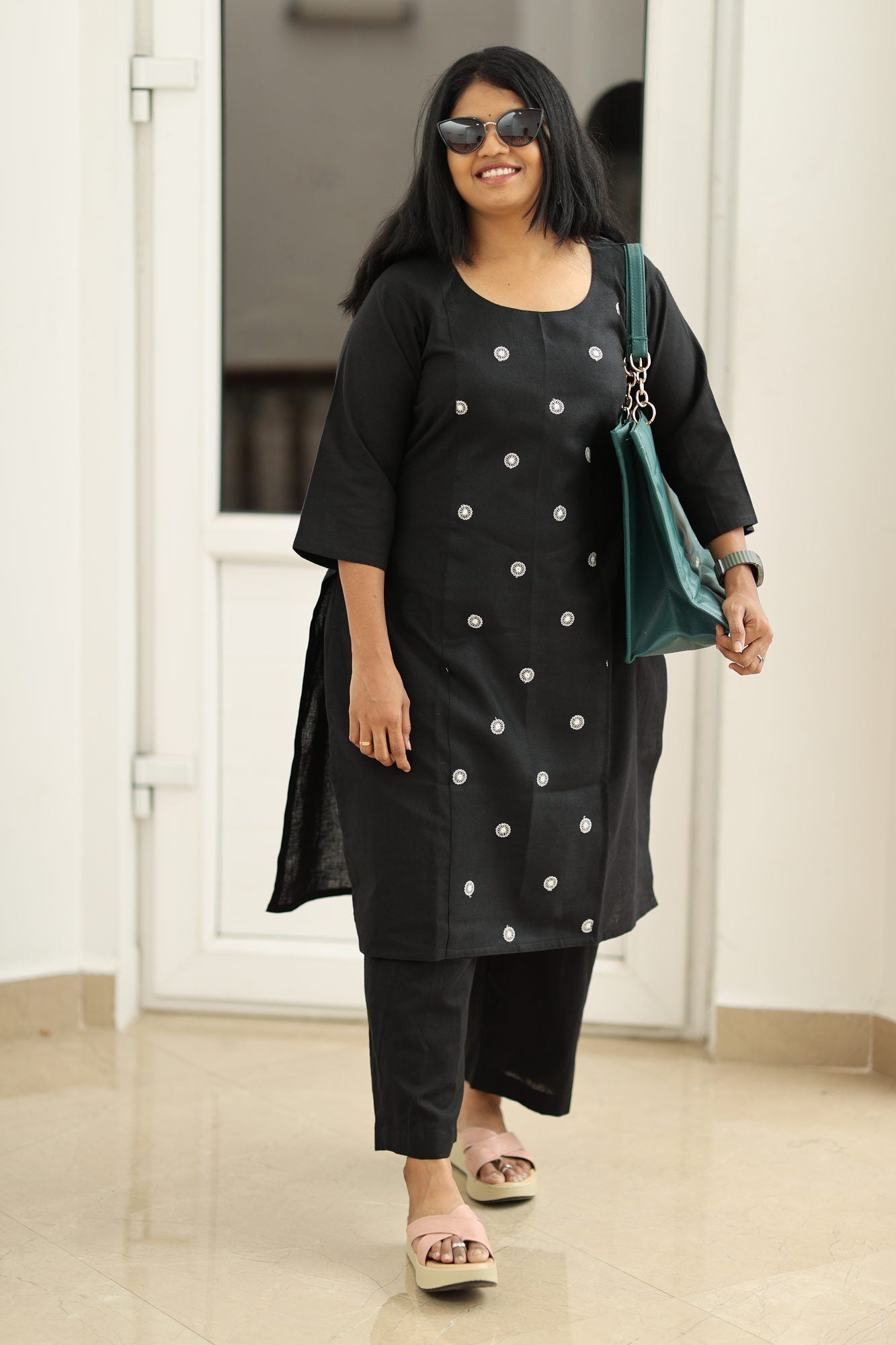 Black embroidered kurta set, styled with a bag