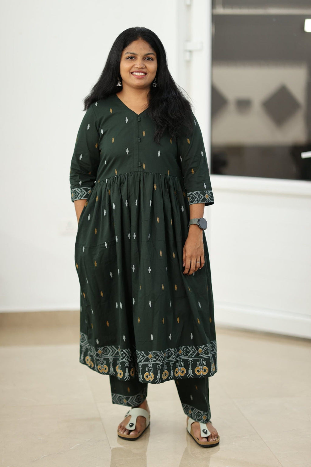 Bottle green patola border kurta set, full front view with the matching pant
