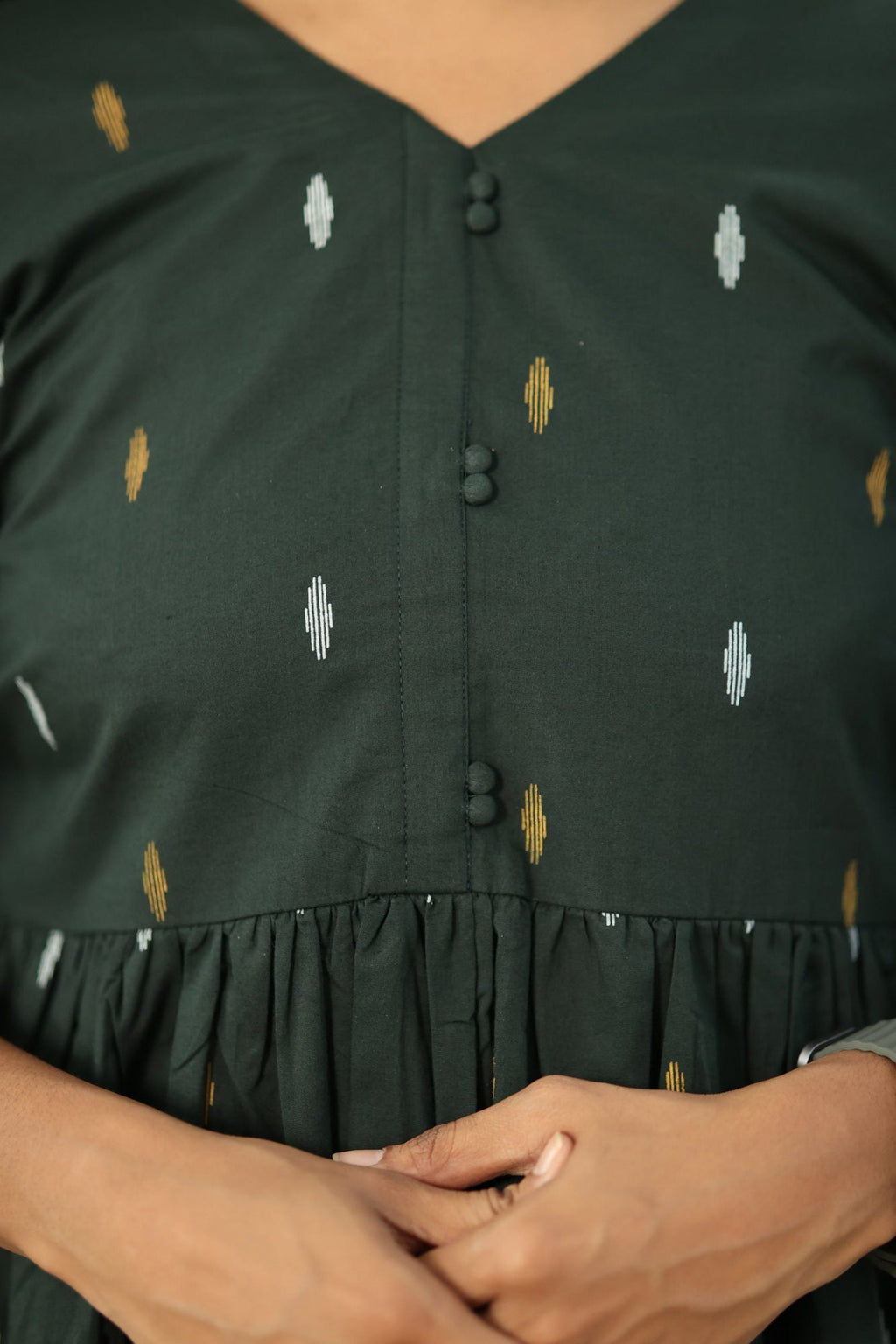 V-neck with fabric-covered buttons