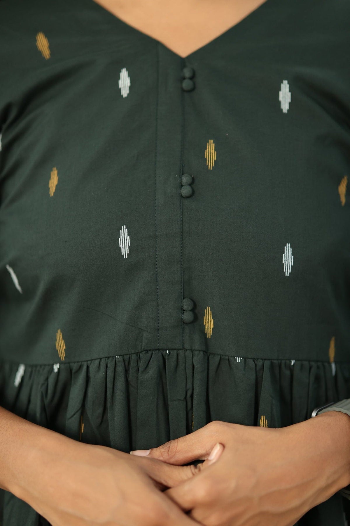 V-neck with fabric-covered buttons