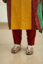 Maroon pant hem with yellow pom-poms