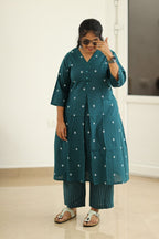 Deep teal kurta set styled with sunglasses