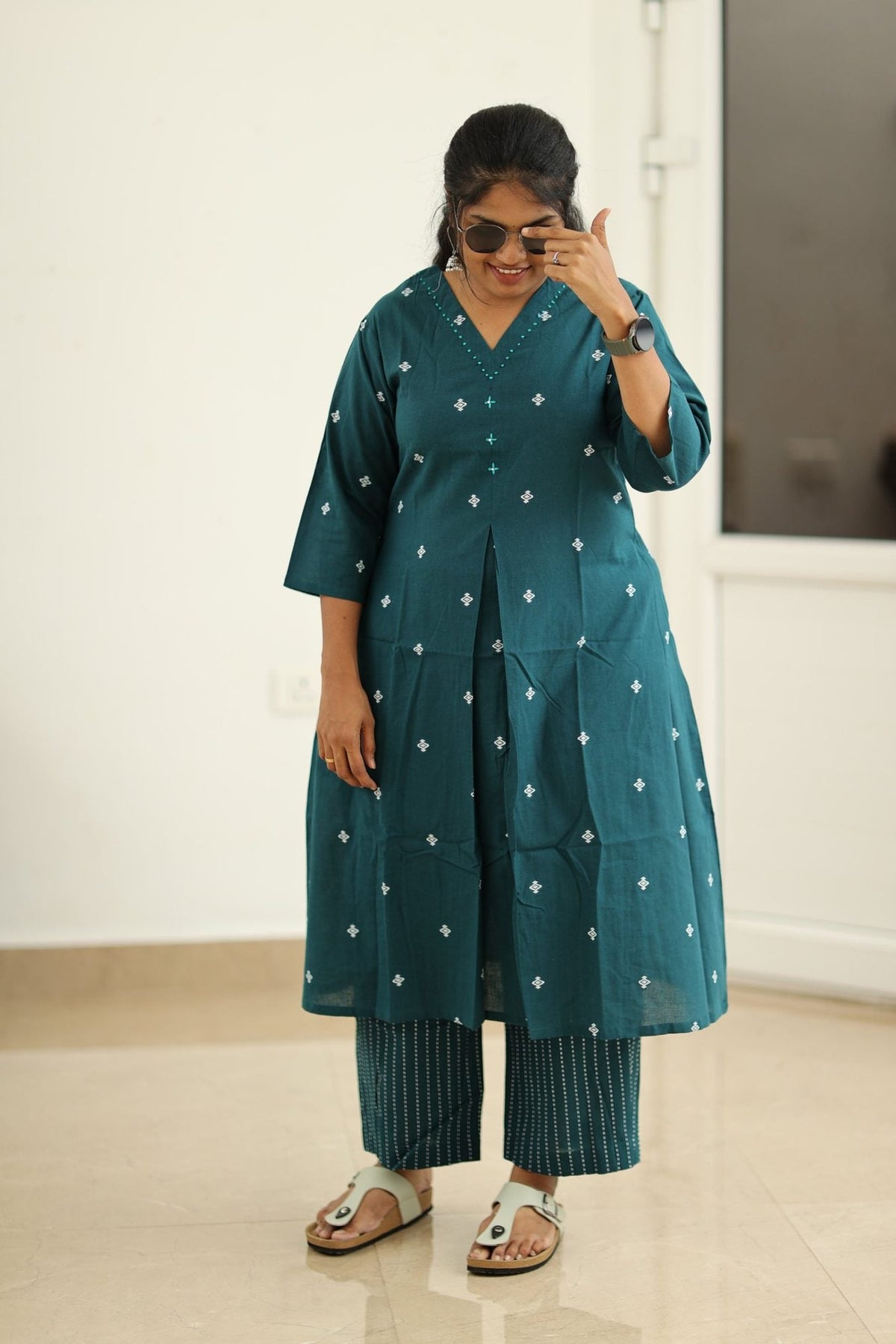 Deep teal kurta set styled with sunglasses