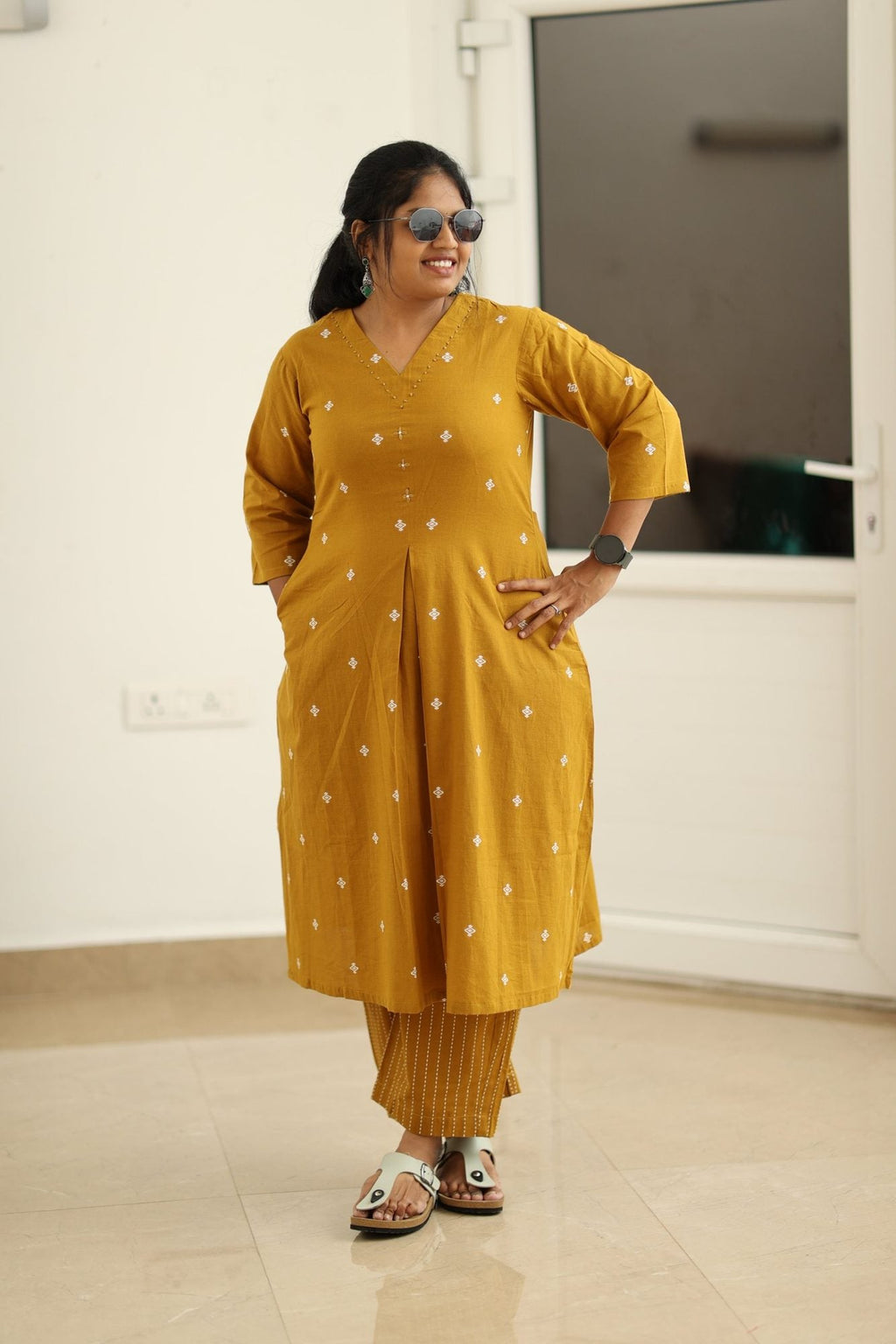 Amber gold kurta set styled with sunglasses