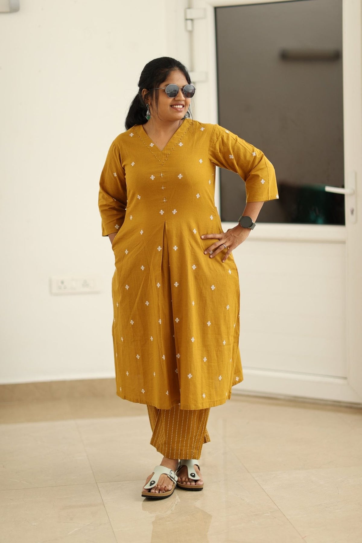 Amber gold kurta set styled with sunglasses