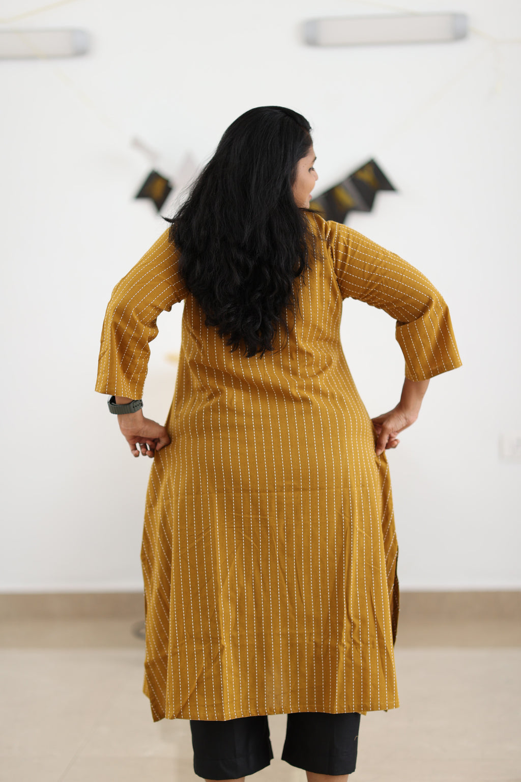 Back view of mustard striped longline office kurta