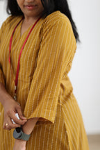 Close-up of sleeve fit on mustard striped office kurta