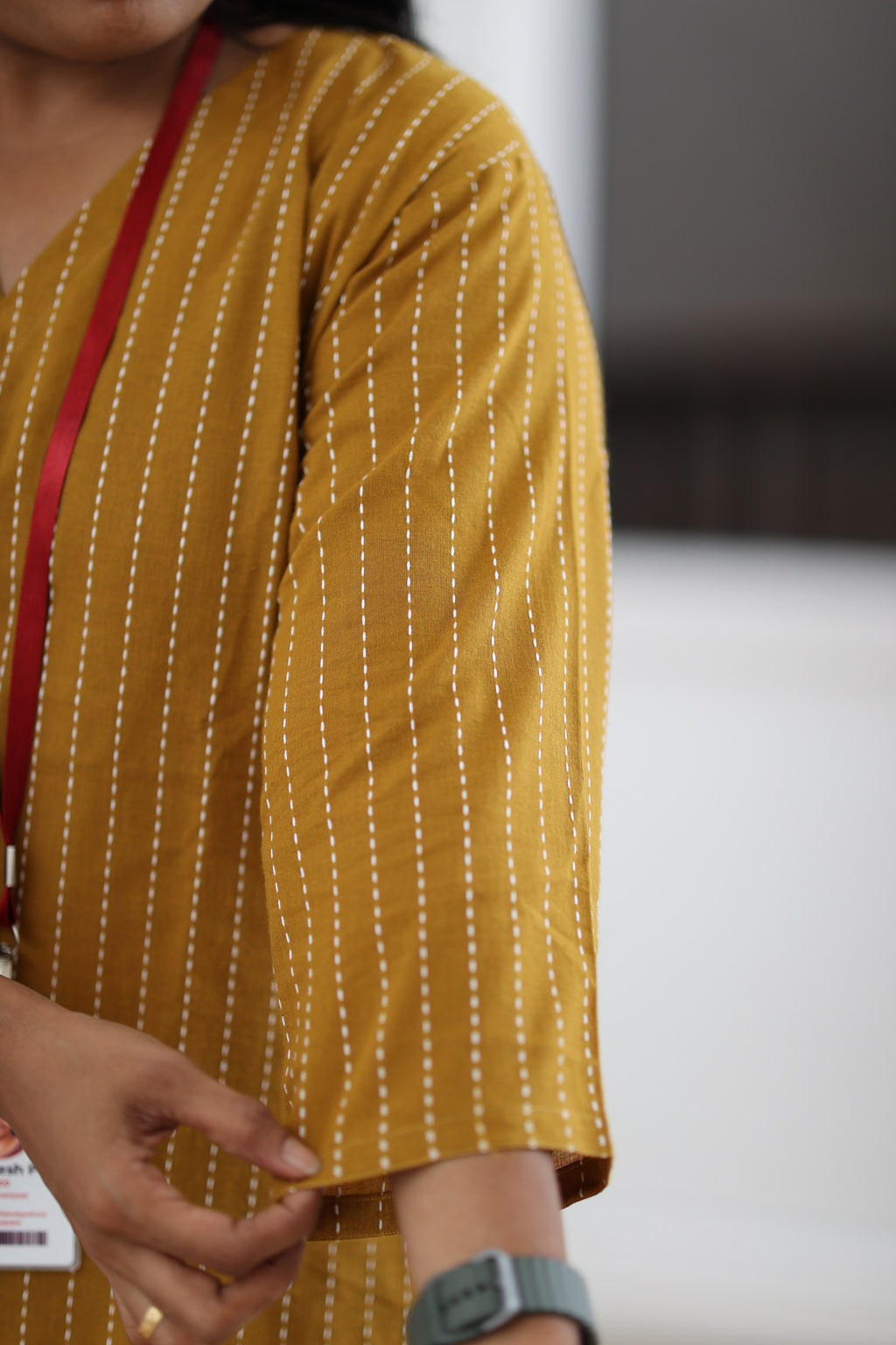 Close-up of three-quarter sleeve and striped zero-finished cotton fabric