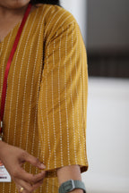 Close-up of three-quarter sleeve and striped zero-finished cotton fabric